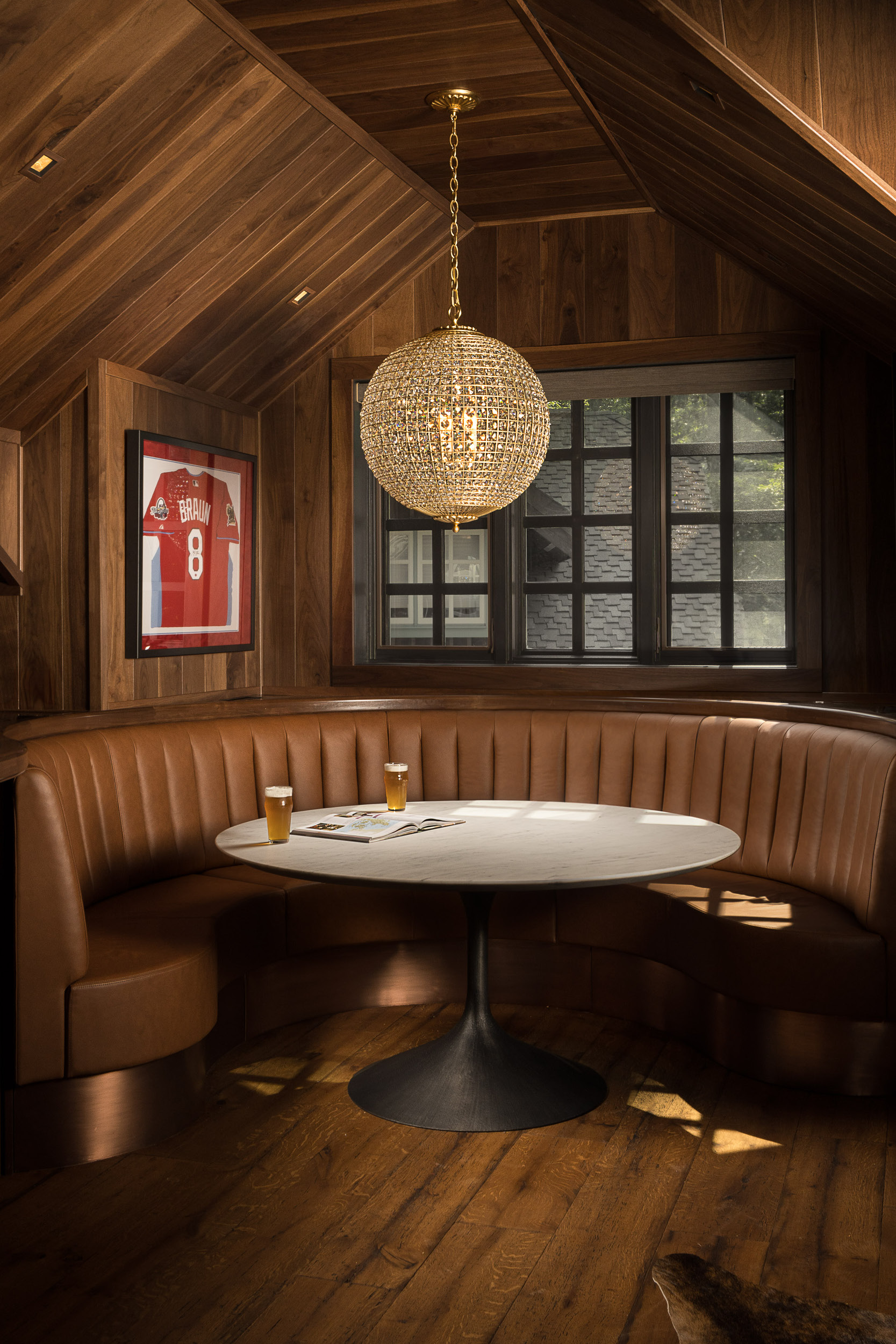 The charming lounge area at the speakeasy lodge featuring craft beer, custom furniture and a statement light fixture