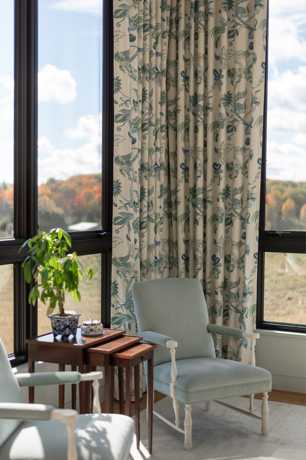 Thoughtful Interior Design for Primary Suite Seating Area with custom furniture and window treatments.