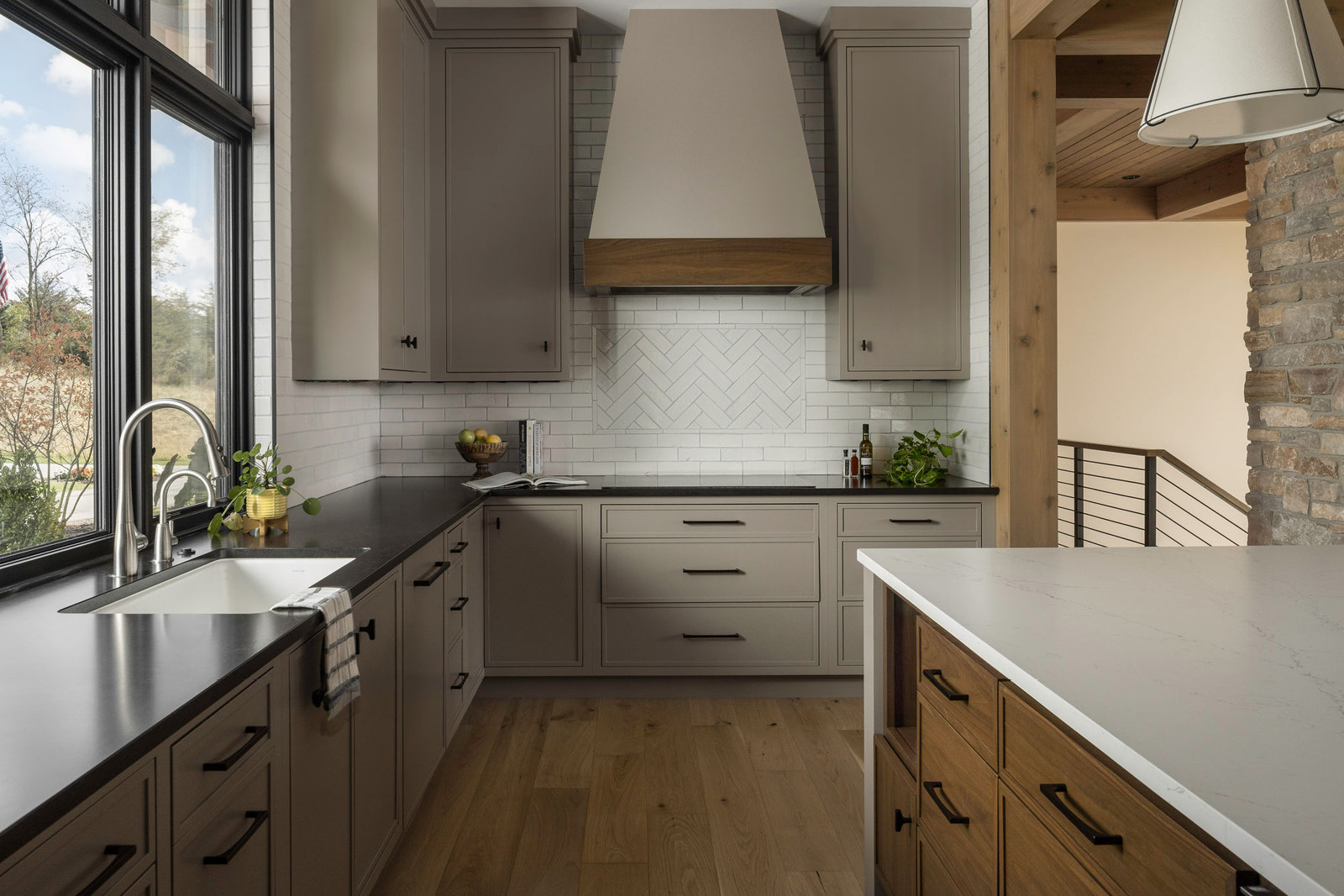 Modern Kitchen Design with custom cabinetry, two toned countertops and intricate tile installation