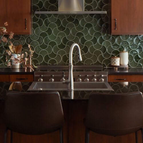The MCM Lake House – Kitchen Detail Mid-century modern lake house kitchen with walnut cabinetry and green fish-scale tile backsplash