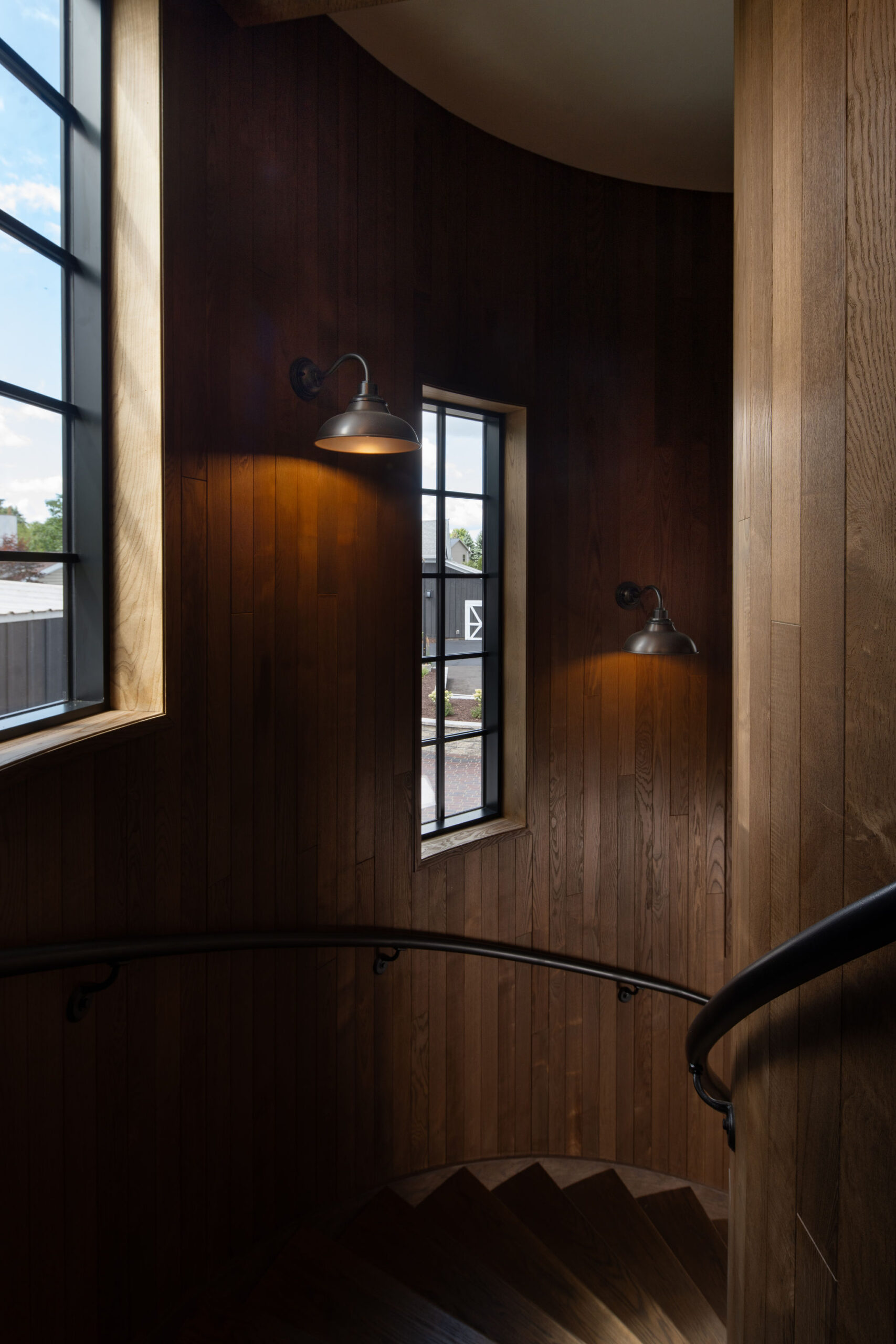 Interior of the wood-clad silo at The Blind Horse Terrace in Kohler, Wisconsin, with curved walls and tall windows