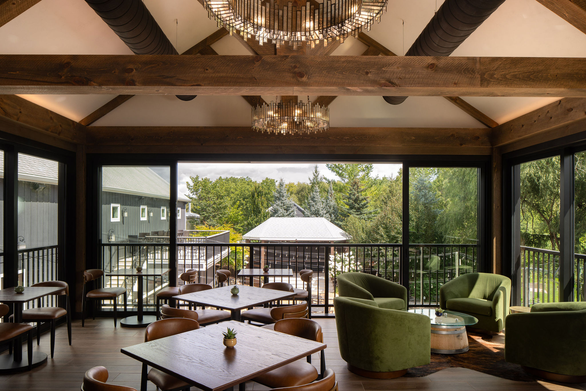 The Lookout at The Blind Horse Terrace with olive lounge seating, exposed wood beams, and expansive windows