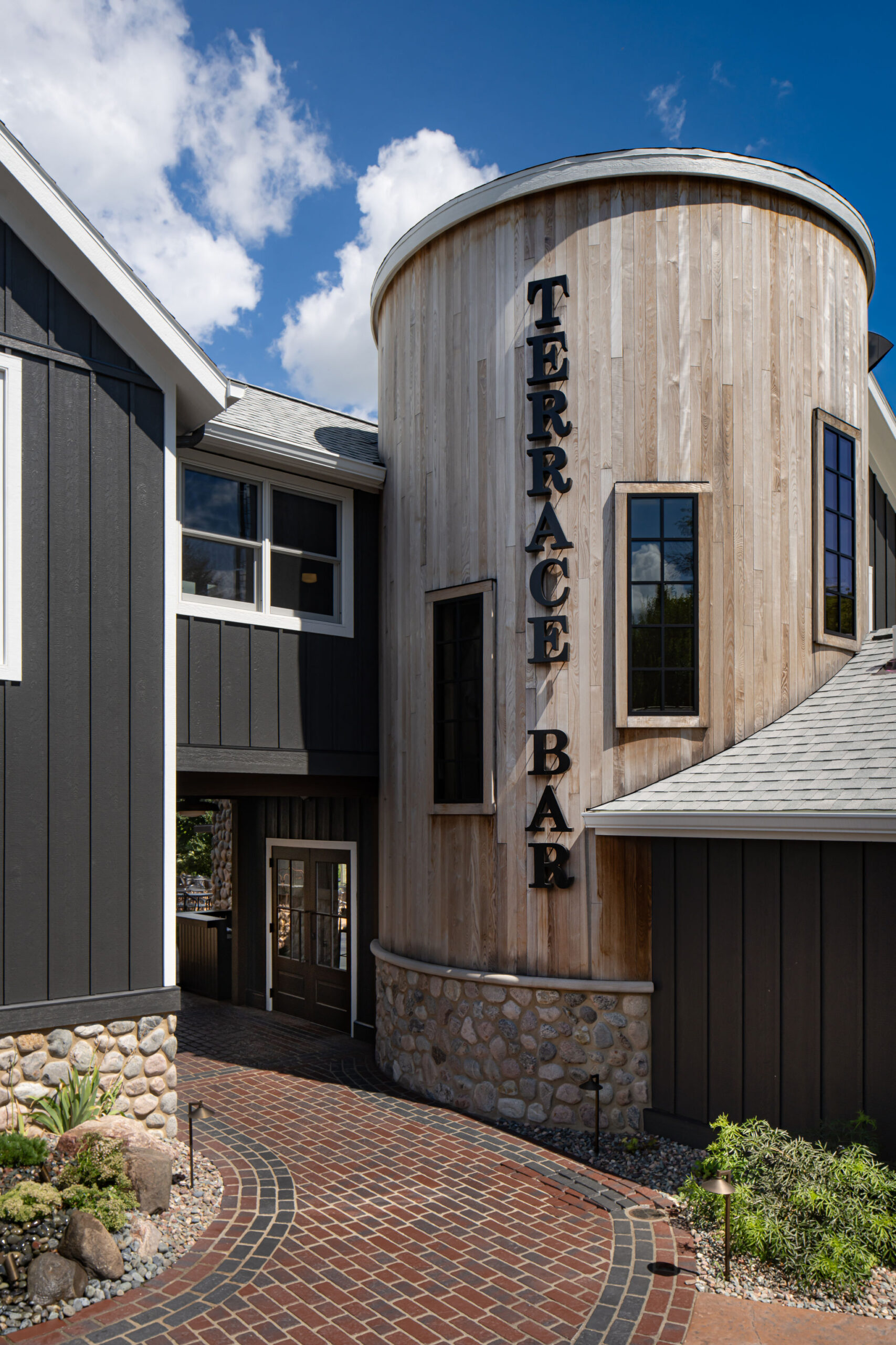 Wood-clad silo at The Blind Horse Terrace in Kohler, Wisconsin, connecting the two-level hospitality addition